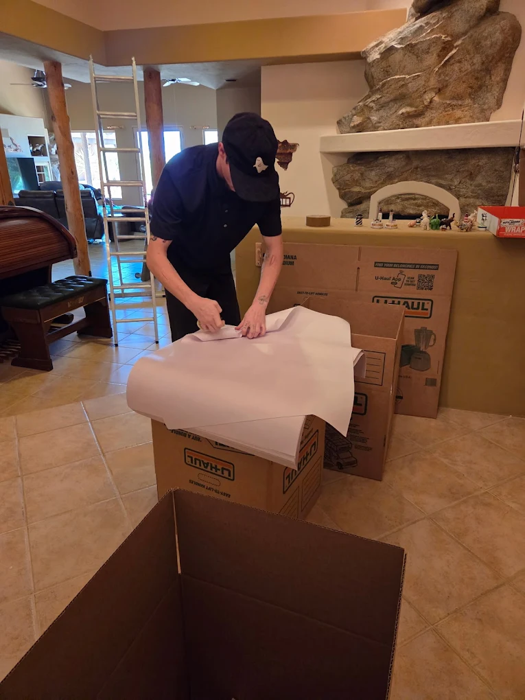 No Hassle Movers team member carefully wrapping kitchen items during a packing job in a Tucson-area home