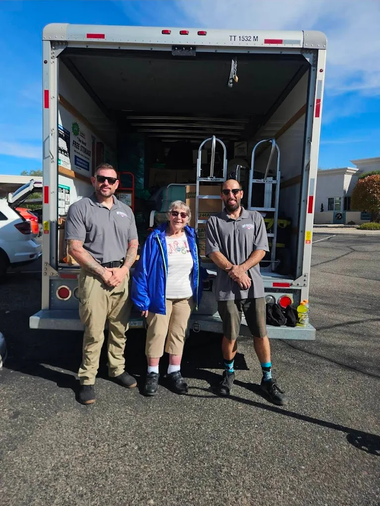 No Hassle Movers crew with a satisfied customer beside a loaded moving truck in Southern Arizona